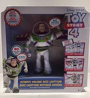 Front view of boxed Ultimate Walking Buzz Lightyear figure showing branding and feature highlights on packaging.