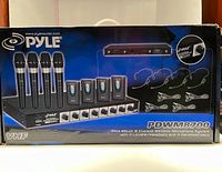 Box front showing all components including rack-mount receiver, handheld mics, lavalier mics, headset mics, and cables