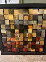 Full view of one wood block wall art piece showing colorful blocks in grid within black frame