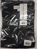 Black vest in factory plastic packaging, visible label shows size Large and brand Uniform Works