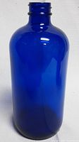Single 16oz blue glass lotion bottle showing full body and threaded neck.