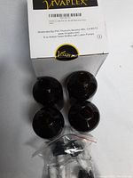 Box of 8 oz amber glass bottles with black lotion pumps, showing four bottles and a bag of pumps on top of a Vivaplex branded box.