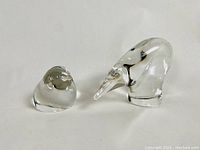 Three mid century modernist clear glass owl paperweights with abstract forms. One identified signed piece present.