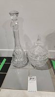 Photo showing both the crystal decanter with stopper and the lidded candy dish side by side