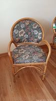 Front view of wicker chair with floral fabric upholstery
