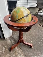 Full view of vintage floor globe and stand