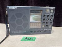 Front view of vintage black Sony ICF-SW7600 AM/FM/Short Wave Radio showing speaker grille, LCD screen, buttons, and controls.