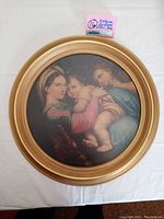 Full view of the round gold wood framed art print showing Madonna and children.