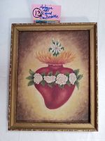 Frontal view of the framed painting showing the floral red heart and surrounding details