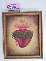 Frontal image of the framed painting showing the Sacred Heart with cross, flames, and crown of thorns.