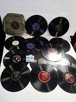 Photo showing over 20 vintage 78 RPM LP records with labels from Victrola and Columbia. Records mostly loose with one in original Columbia sleeve, all with visible wear and need cleaning.