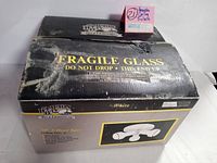 Top angled view of original box showing Hampton Bay branding and fragile glass warning.