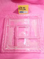 Clear square divided glass plate with frosted ridged edges shown from top to display overall shape and divisions.