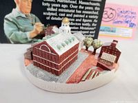 Photo of the handpainted miniature of Faneuil Hall and Quincy Market with detailed textured pavements, trees, and golden-domed cupola.