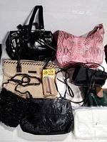 Overview of nine vintage handbags and clutches of varying colors and materials arranged side by side on white backdrop
