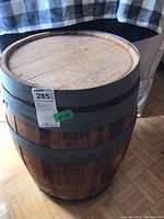Full view of the barrel showing the wooden top and metal bands around the wood staves