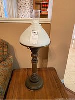 Full view of the vintage lamp showing wooden turned base, metal base plate, and ribbed white glass shade with clear chimney.