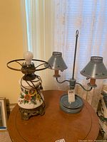 Photo showing the handpainted glass lamp base with floral design and the two metal candle lamps with two tiers and floral metal shades.