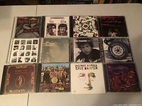Lot of 12 music CDs showing album covers, arranged in two rows of six each.