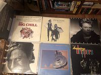 Overview of all six LP vinyl records laid out on a table with bookshelf in background, showing covers and condition.