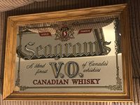 Full front view of Seagrams V.O. branded mirror showing logo, text and wood frame