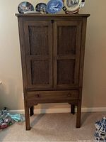 Front view of cabinet showing doors, drawer and legs