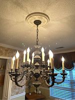 Full-room view of chandelier hanging above dining table