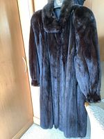 Full-length front view of mink coat hanging