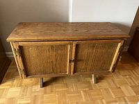 Front view of the vintage oak side table cabinet showing double door design and wood grain.
