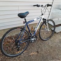 Left-side full view of Trek 7100 bike showing seat, frame, tires, pedals, and handlebars