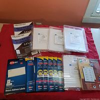 Overview of the entire lot displayed on red cloth surface including labels and holders