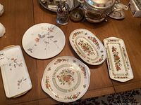 Top view of five floral patterned German china pieces on table