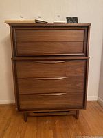 Front view of tall dresser showing overall appearance and drawer layout