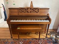 Front view of Knight upright piano with matching bench