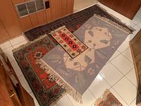 Four rugs overlapped on tiled floor