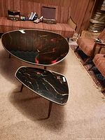 Both tables assembled and upright showing tabletop patterns and leg style