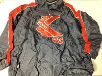 Front view of the 1990s Kani Sport blue and red jacket with large Kani 23 logo on the chest and red stripes on sleeves.