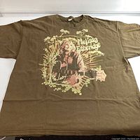 Front of brown Melissa Etheridge graphic T-shirt showing detailed print with musician and floral design.