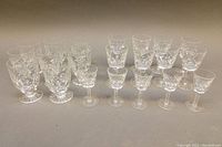 Full set of 21 Waterford cut crystal glasses arranged in rows by size