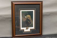 Framed print with golden eagle portrait, wooden frame with matting