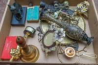 Top-down view of box with all assorted brassware and decorative items showing layout and condition