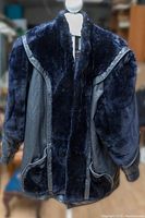 Full front view showing large fur collar, front panels, and leather sides and sleeves