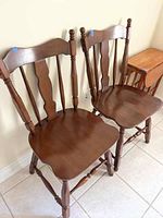 Two solid maple chairs shown side by side, showing their overall shape, wood finish and style.