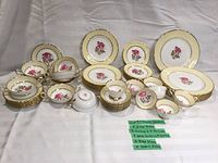 Full layout showing all plates, cups, bowls and creamer