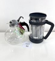 Side view of the glass stovetop kettle and Bialetti cold brew coffee maker, both new and unused