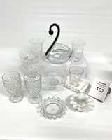 Full lot displaying all vintage glassware items including hobnail glasses, swan decanter, ashtray, and several clear decorative glasses and bowls