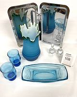 Photo of MCM glass decor items: blue-green vase, two cobalt glasses, blue rectangular dish, two crystal candle holders, and vintage chrome tray with handle