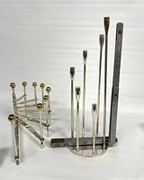 Full front view of Hanukkiah with brass accents next to modern candleholder, includes tape measure for scale