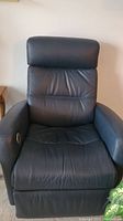 Front view of blue leather recliner showing cushioned backrest, seat, and armrests