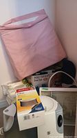 Holmes humidifier units stacked with wedge pillow, foot spa box, Huggies wipes, and frame visible in background